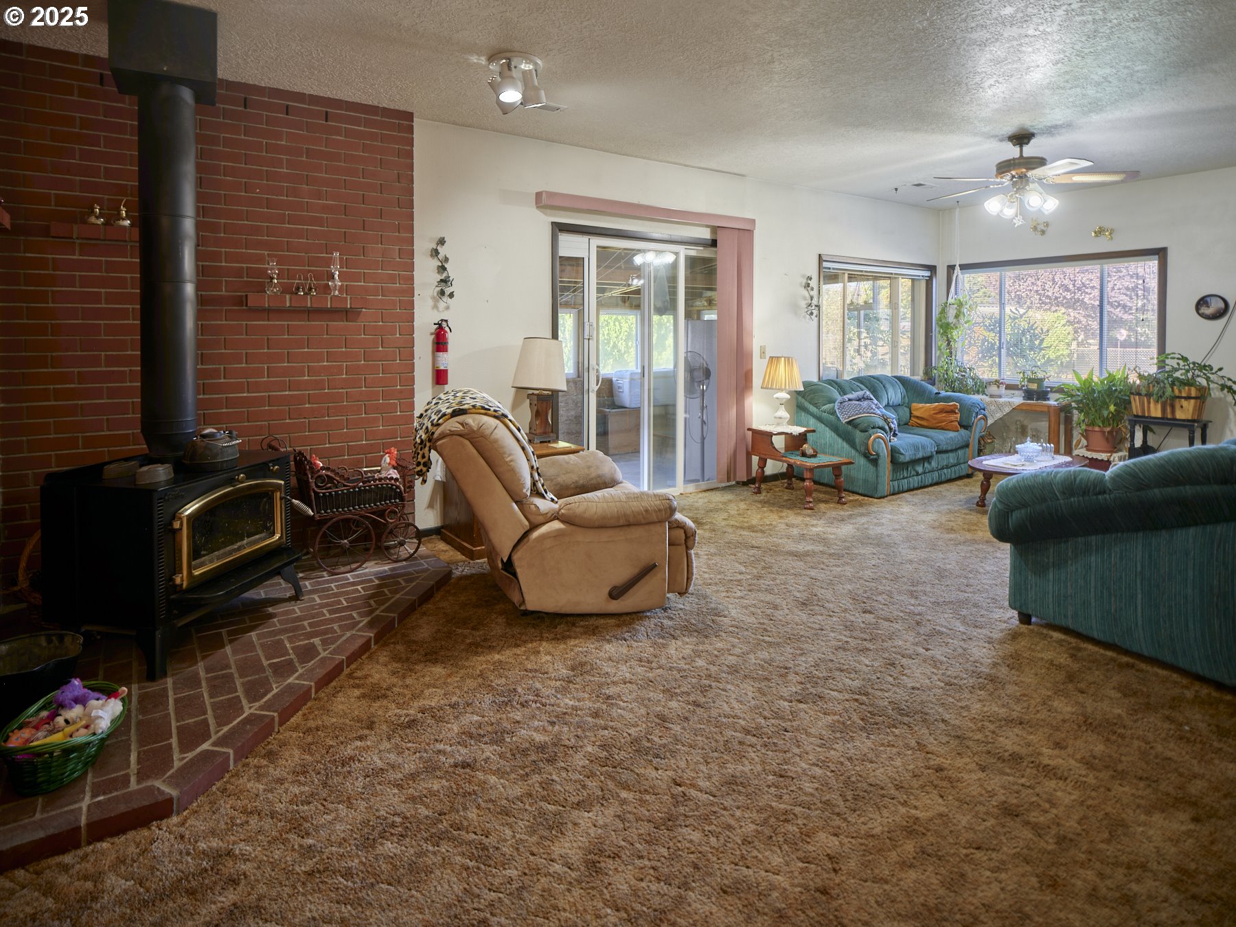 115 Whalen Loop Road Woodland, WA 98674 - Photo 17 of 40 a living room with furniture a lamp and a window