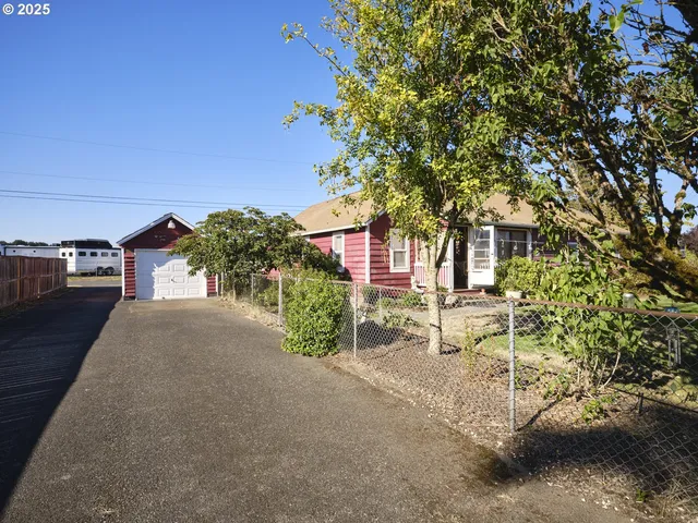a row of palm trees in front of a house