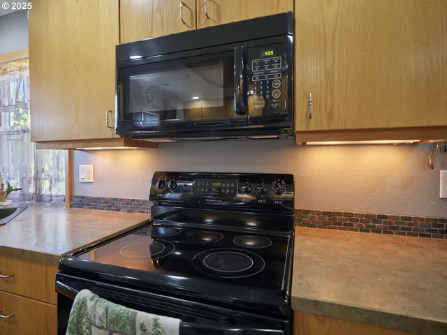 a kitchen with stainless steel appliances granite countertop a sink and a window