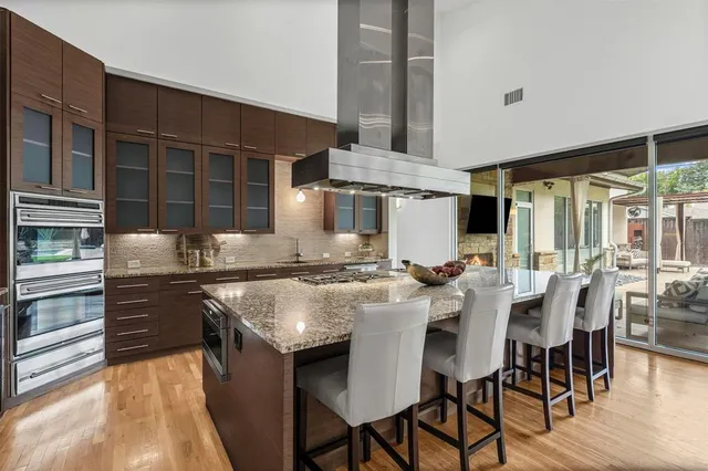 a kitchen with a stove and a wooden floor