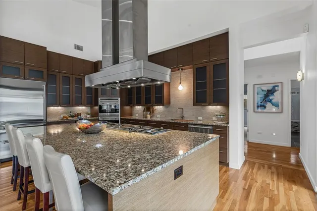 a kitchen with stainless steel appliances granite countertop a sink stove and refrigerator