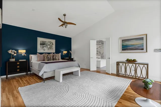 a bedroom with furniture and a large window