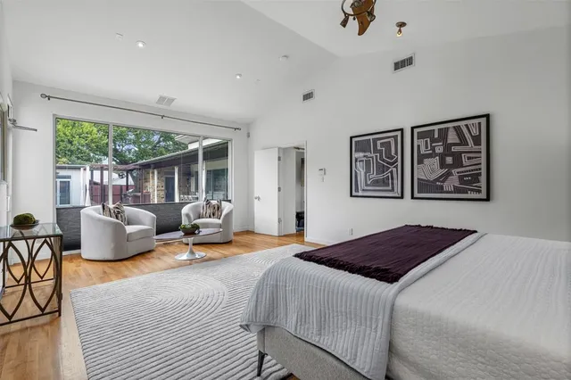 a bedroom with a bed and wooden floor