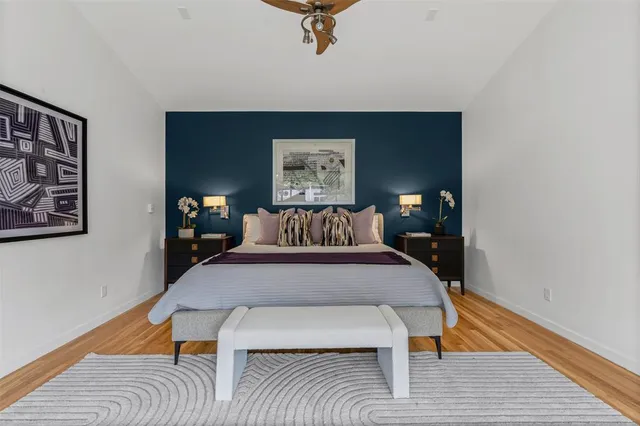 a room with kitchen island stainless steel appliances a chandelier furniture and windows