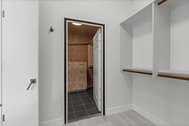 a living room with furniture a flat screen tv and a large window
