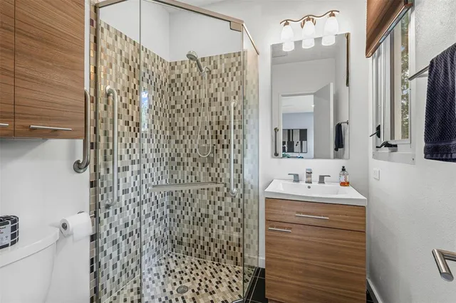 an empty room with windows and ceiling fan