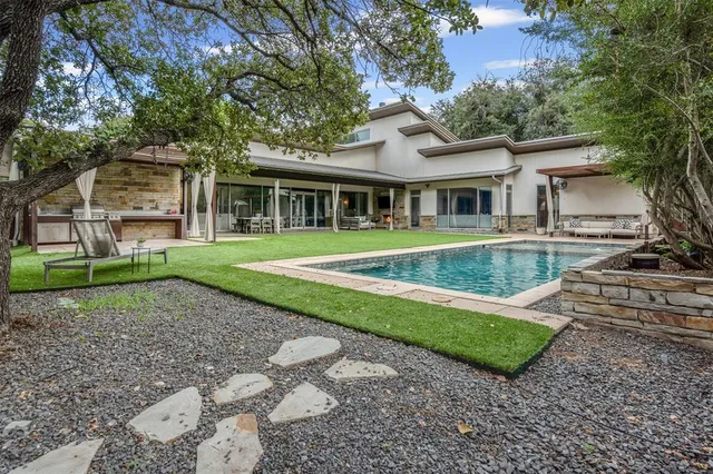 front view of a brick house with a big yard
