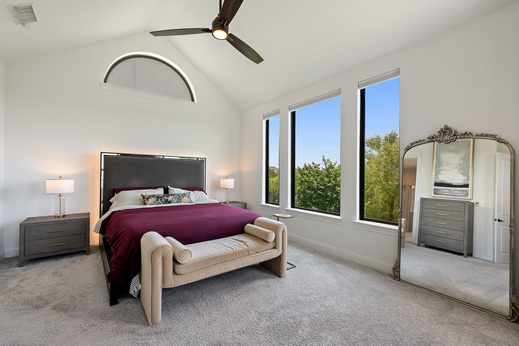1221 Siena Sunset Road Leander, TX 78641 - Photo 21 of 39 Vaulted ceiling with an arched window and a ceiling fan