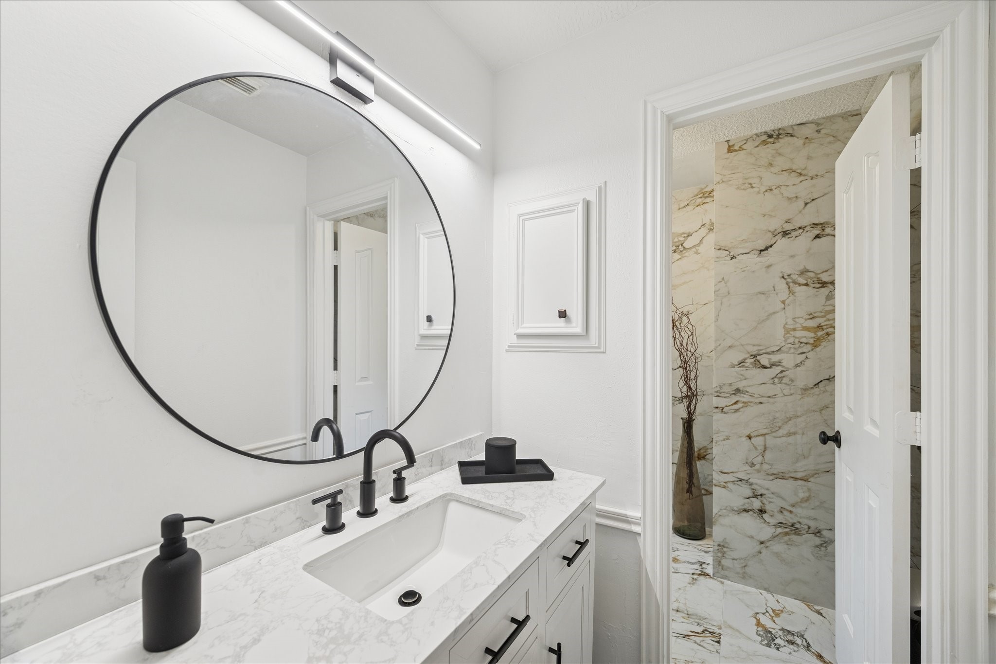6787 Monarda Court Houston, TX 77069 - Photo 21 of 33 a bathroom with a sink a vanity and a mirror
