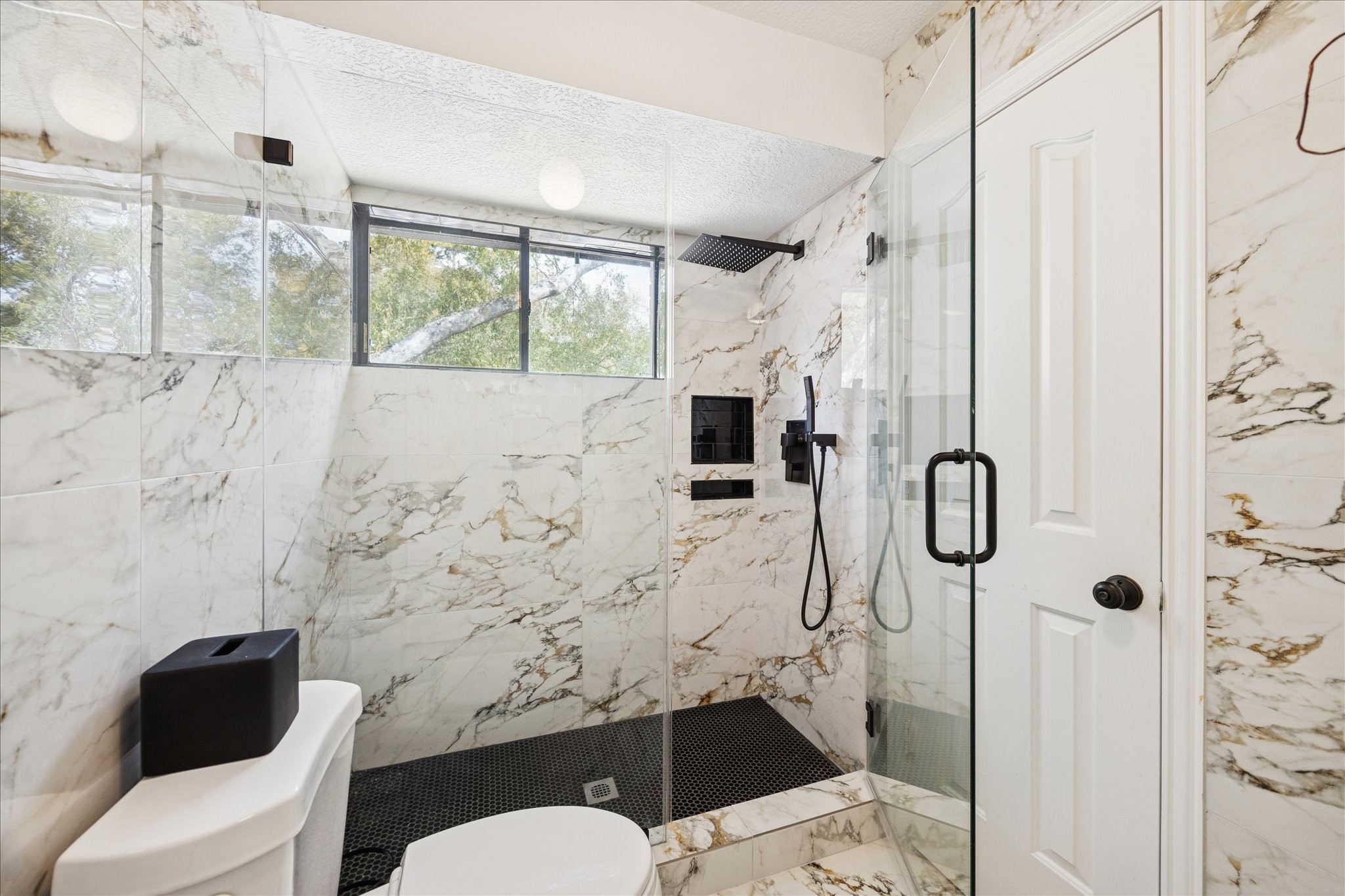 6787 Monarda Court Houston, TX 77069 - Photo 25 of 33 a bathroom with a toilet sink and shower