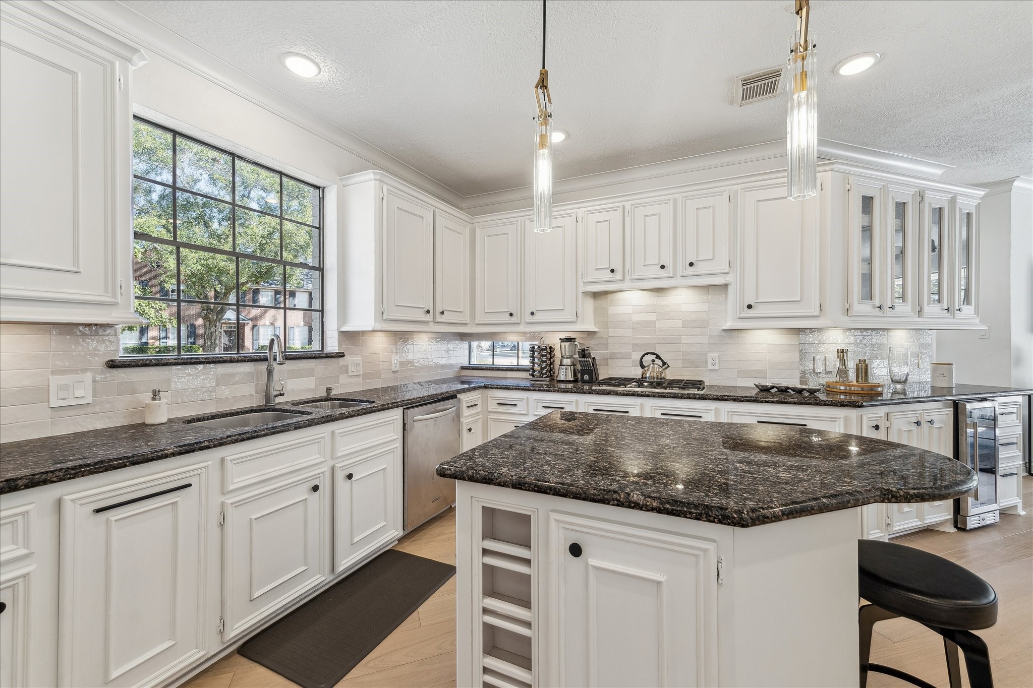 6787 Monarda Court Houston, TX 77069 - Photo 5 of 33 a kitchen with granite countertop a sink window and cabinets