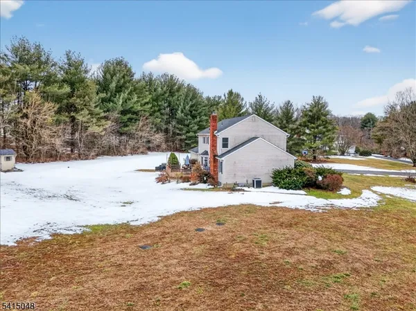 a view of a house with a yard covered in snow