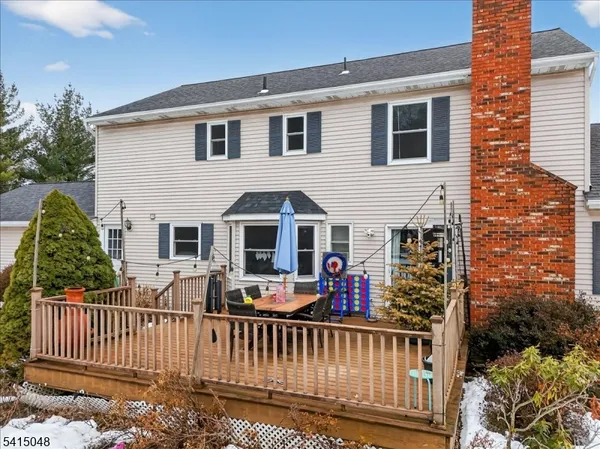 a front view of house with deck and outdoor seating