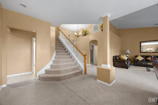 a view of a dining room with furniture and chandelier
