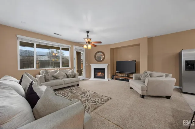 a kitchen with stainless steel appliances granite countertop a refrigerator a sink dishwasher a stove and a refrigerator