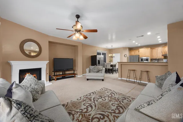 a large kitchen with kitchen island a sink a stove a dining table and chairs