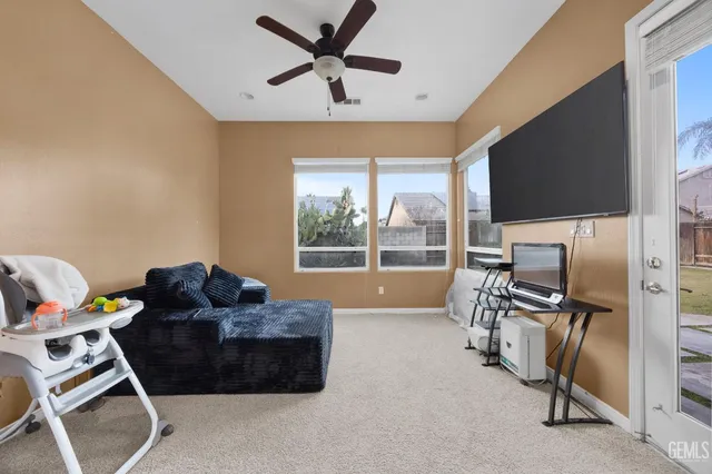 a spacious bedroom with a bed and a refrigerator