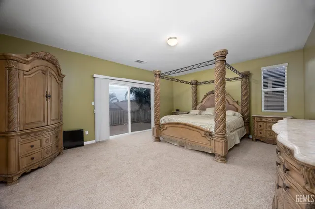 a living room with a couch and a dresser next to a window