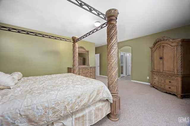 a bedroom with a bed and a desk