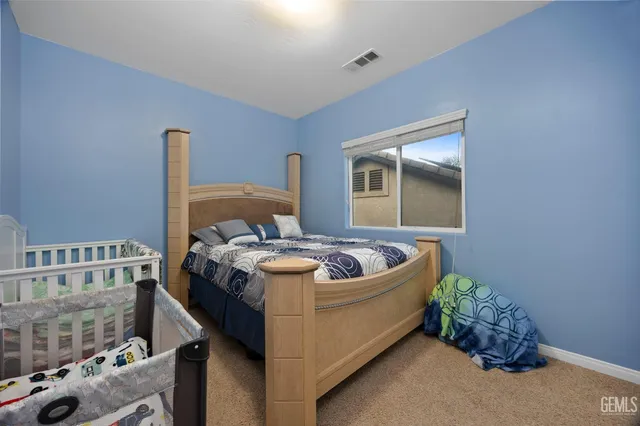 a bedroom with two beds and a flat screen tv