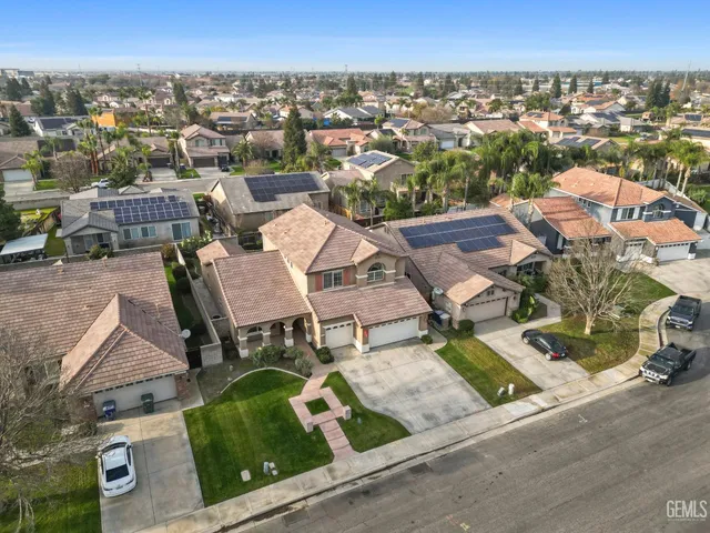 an aerial view of residential houses with outdoor space and city view