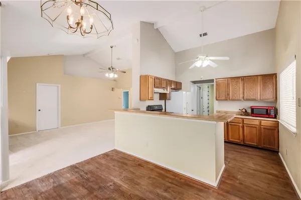 a kitchen with stainless steel appliances granite countertop a stove and a refrigerator
