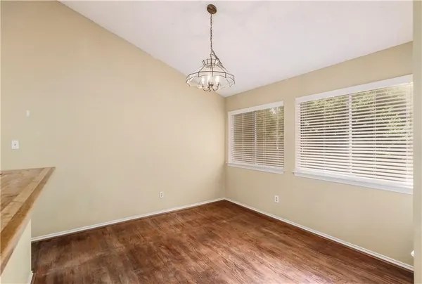 a view of a room with a window and wooden floor