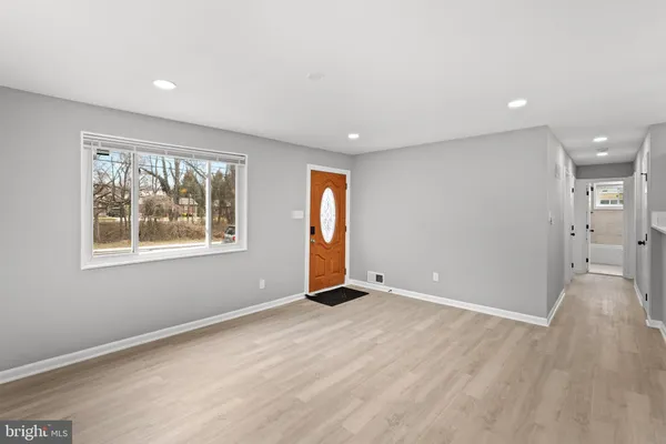 an empty room with windows and closet