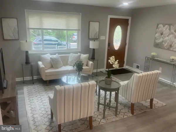 a living room with furniture and a large mirror
