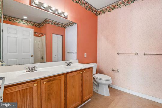 9511 Kingscroft Terrace, Unit 9511F Perry Hall, MD 21128 - Photo 31 of 38 a bathroom with a sink a toilet and shower