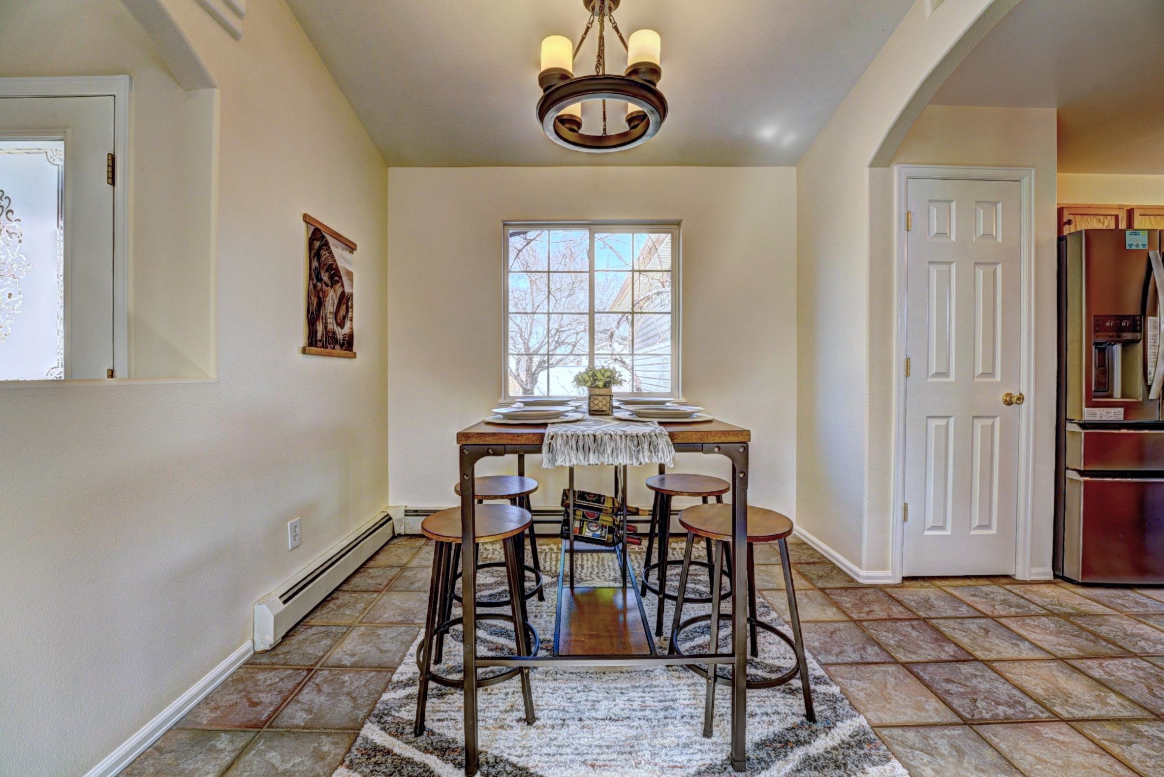 1460 Powell Street Fruita, CO 81521 - Photo 11 of 35 a view of a dining room with furniture window and wooden floor