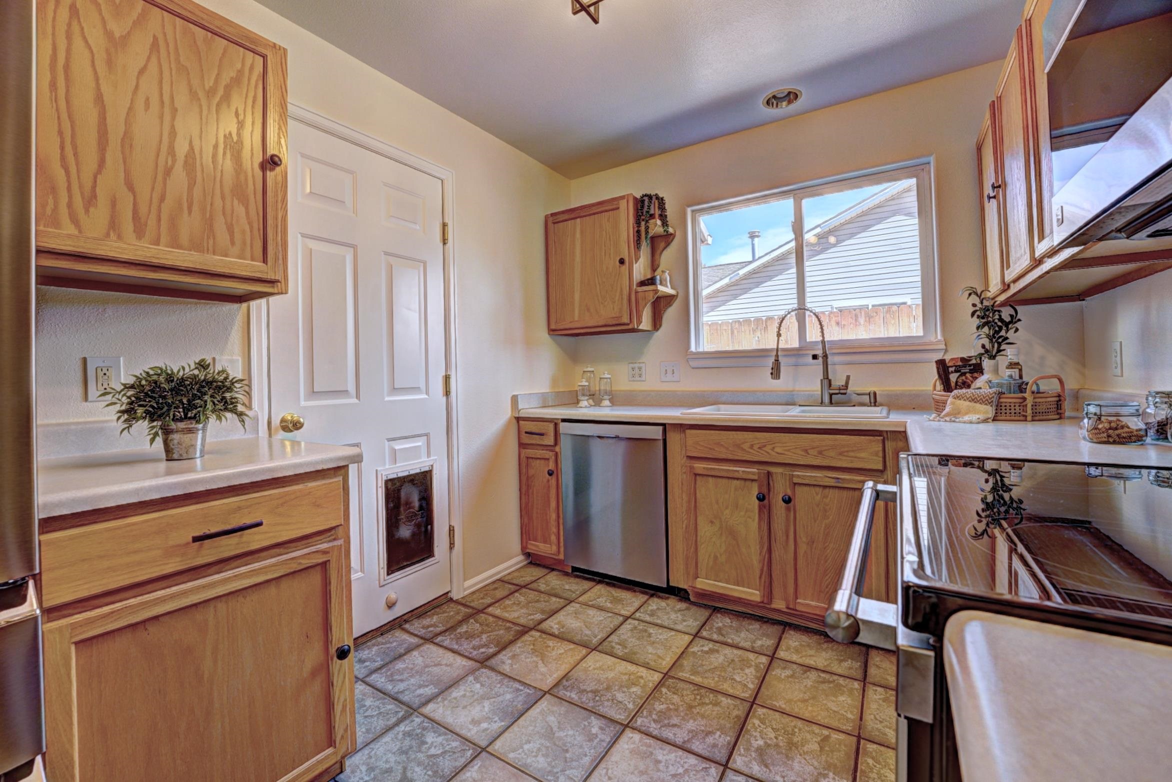 1460 Powell Street Fruita, CO 81521 - Photo 14 of 35 a kitchen with a sink stove and cabinets