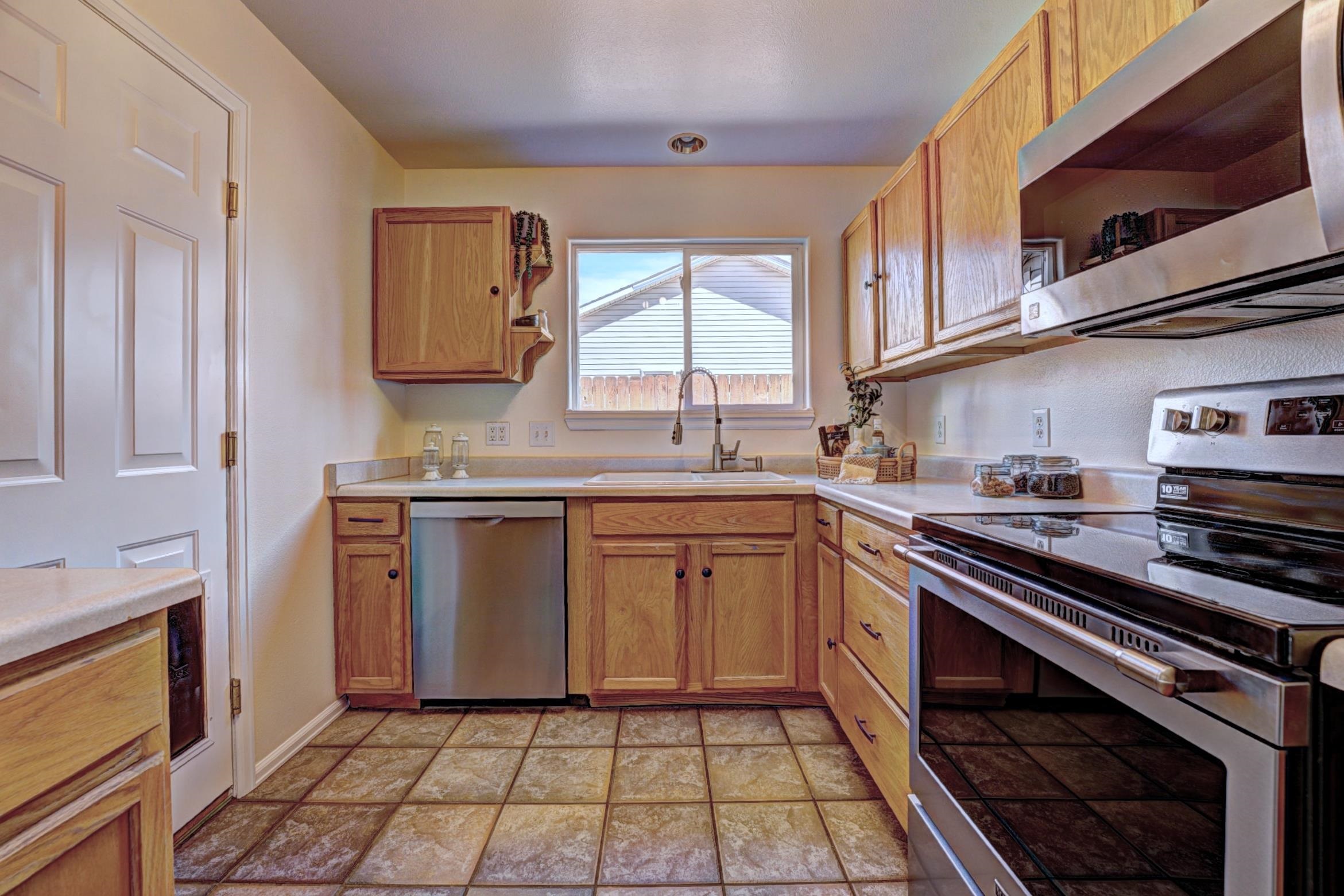 1460 Powell Street Fruita, CO 81521 - Photo 15 of 35 a kitchen with stainless steel appliances a sink stove and cabinets