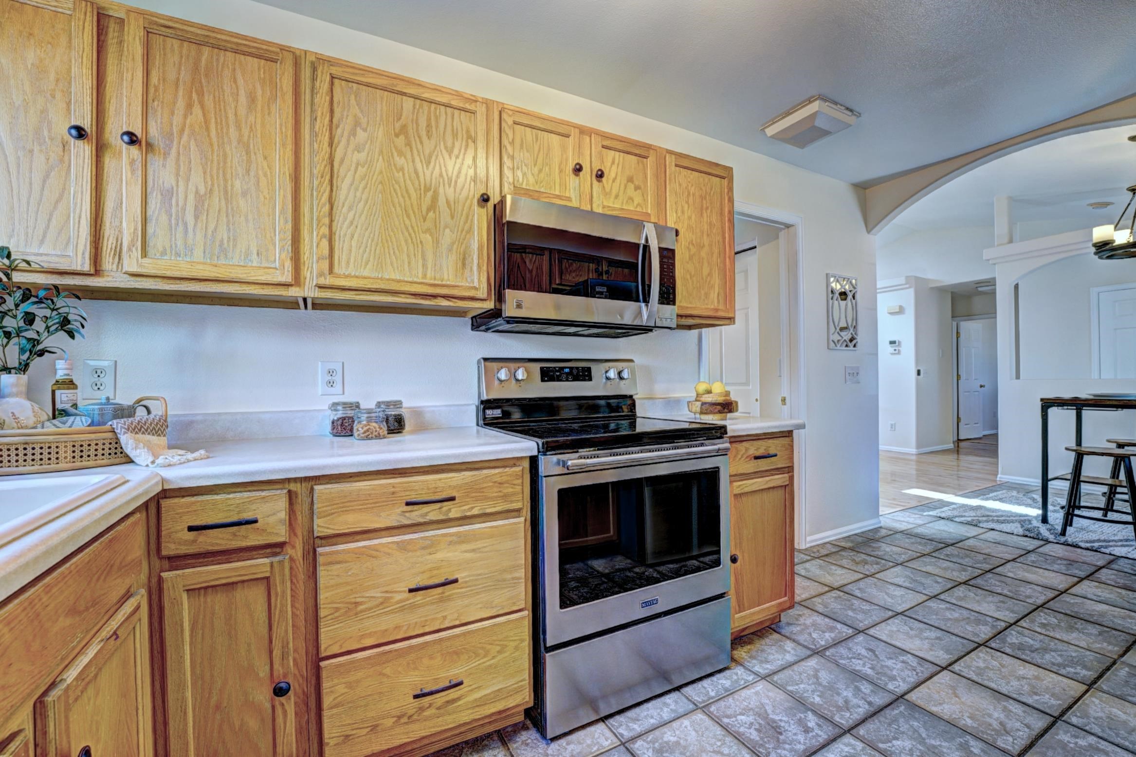 1460 Powell Street Fruita, CO 81521 - Photo 16 of 35 a kitchen with stainless steel appliances granite countertop a stove microwave and cabinets