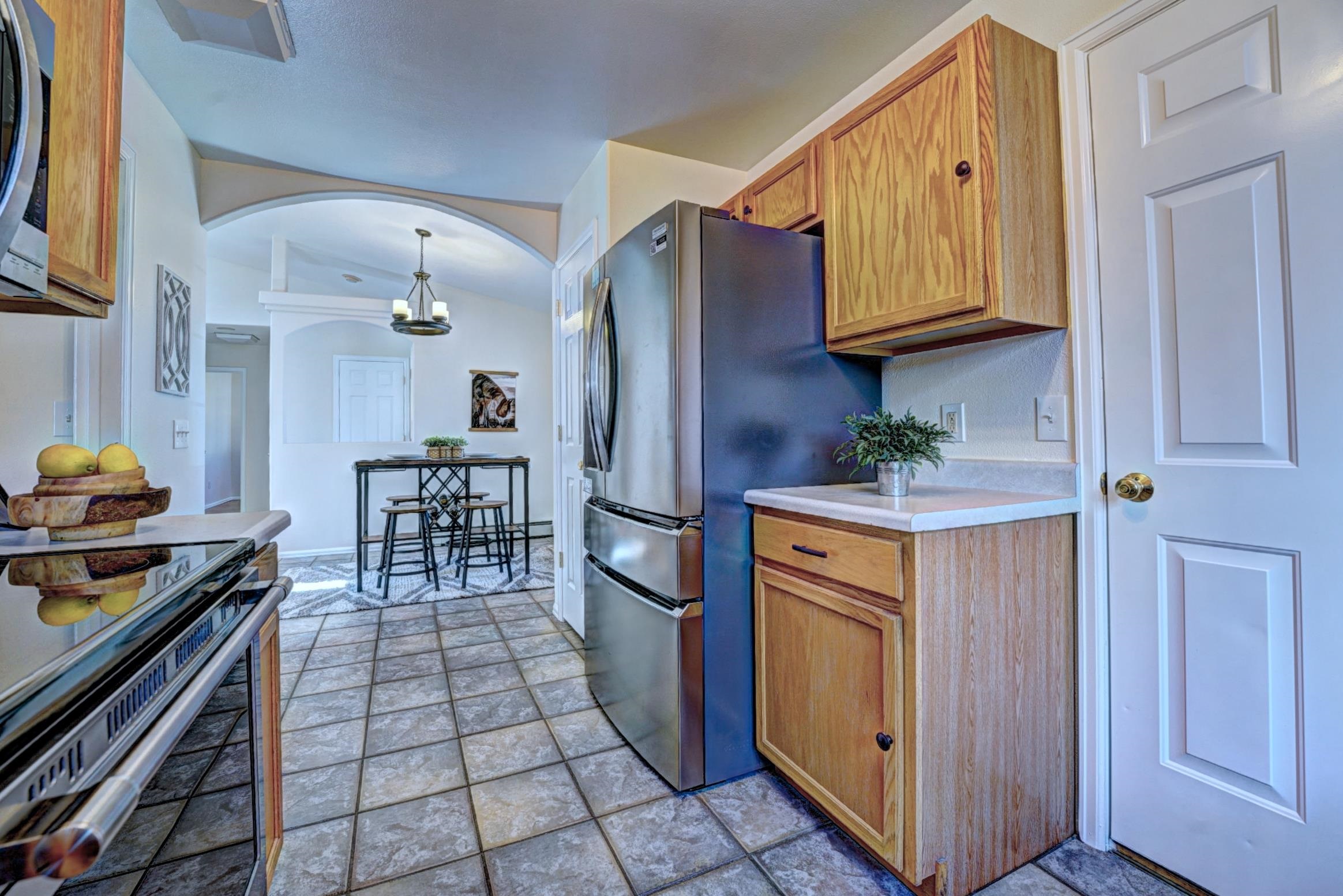 1460 Powell Street Fruita, CO 81521 - Photo 17 of 35 a kitchen with stainless steel appliances granite countertop a refrigerator and a stove top oven