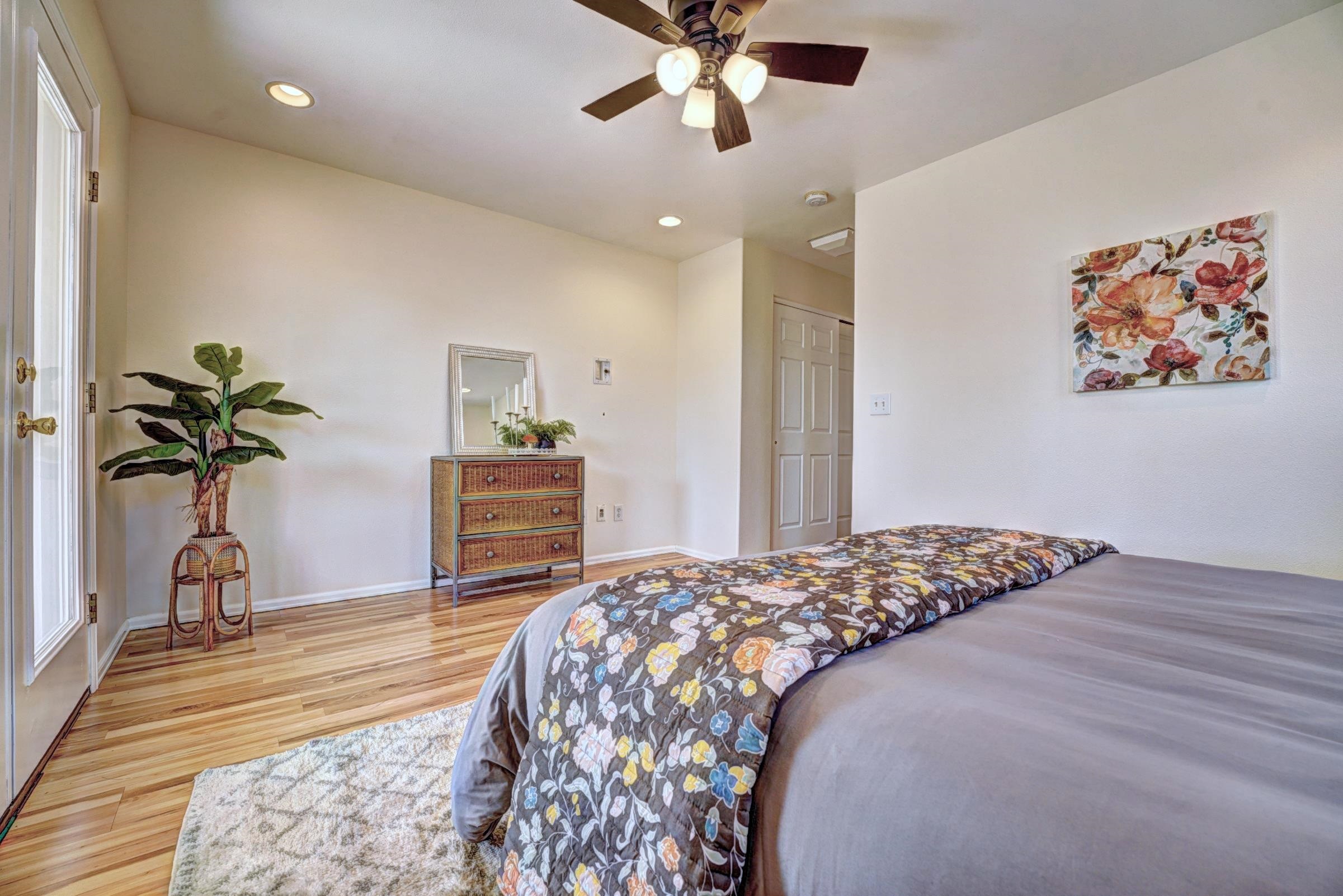 1460 Powell Street Fruita, CO 81521 - Photo 21 of 35 a bedroom with a bed and a chandelier