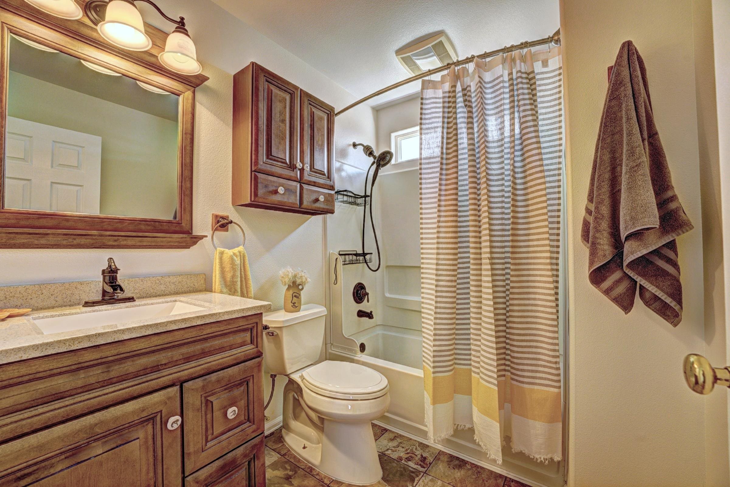 1460 Powell Street Fruita, CO 81521 - Photo 28 of 35 a bathroom with a granite countertop sink toilet and shower