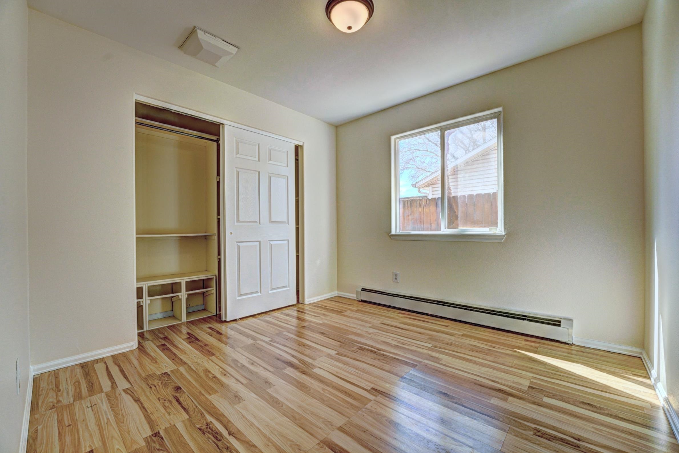 1460 Powell Street Fruita, CO 81521 - Photo 29 of 35 an empty room with wooden floor closet and windows
