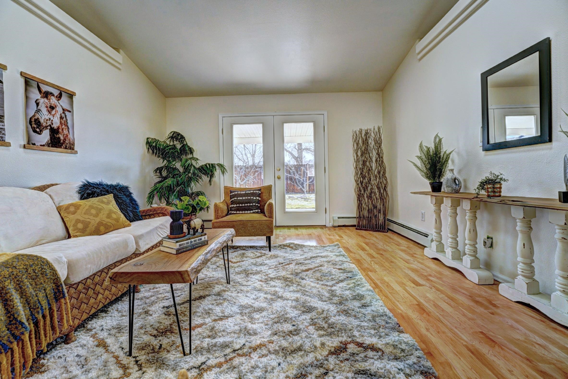 1460 Powell Street Fruita, CO 81521 - Photo 9 of 35 a living room with furniture and a wooden floor