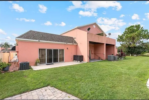 a backyard of a house with table and chairs