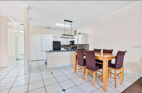 a view of kitchen and dining area with chandelier