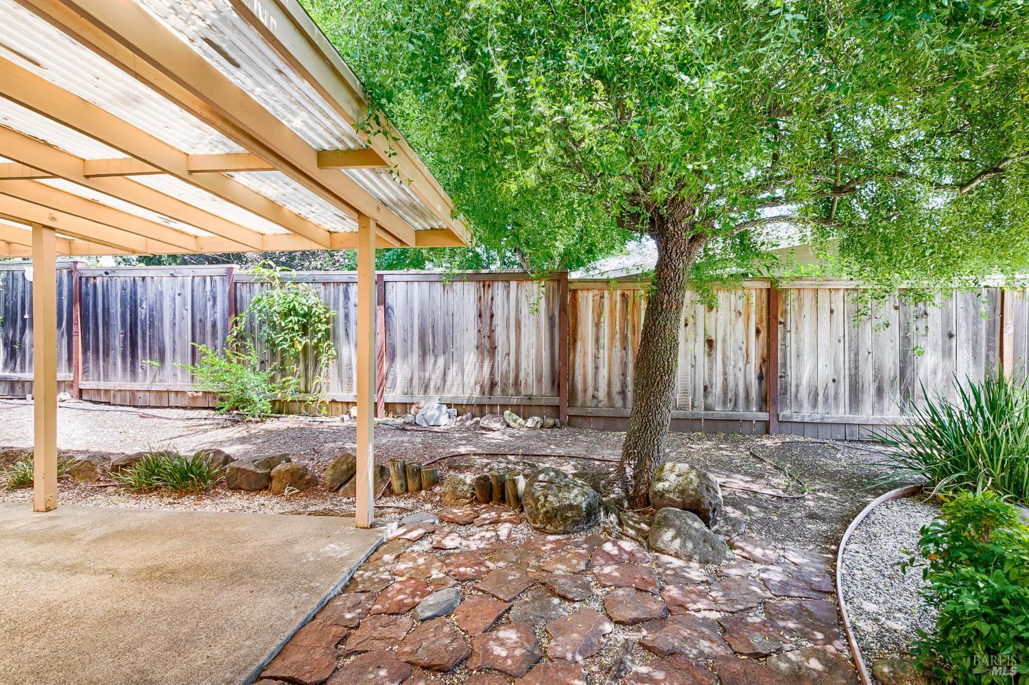 138 Oak Shadow Drive Santa Rosa, CA 95409 - Photo 40 of 50 a backyard of a house with table and chairs