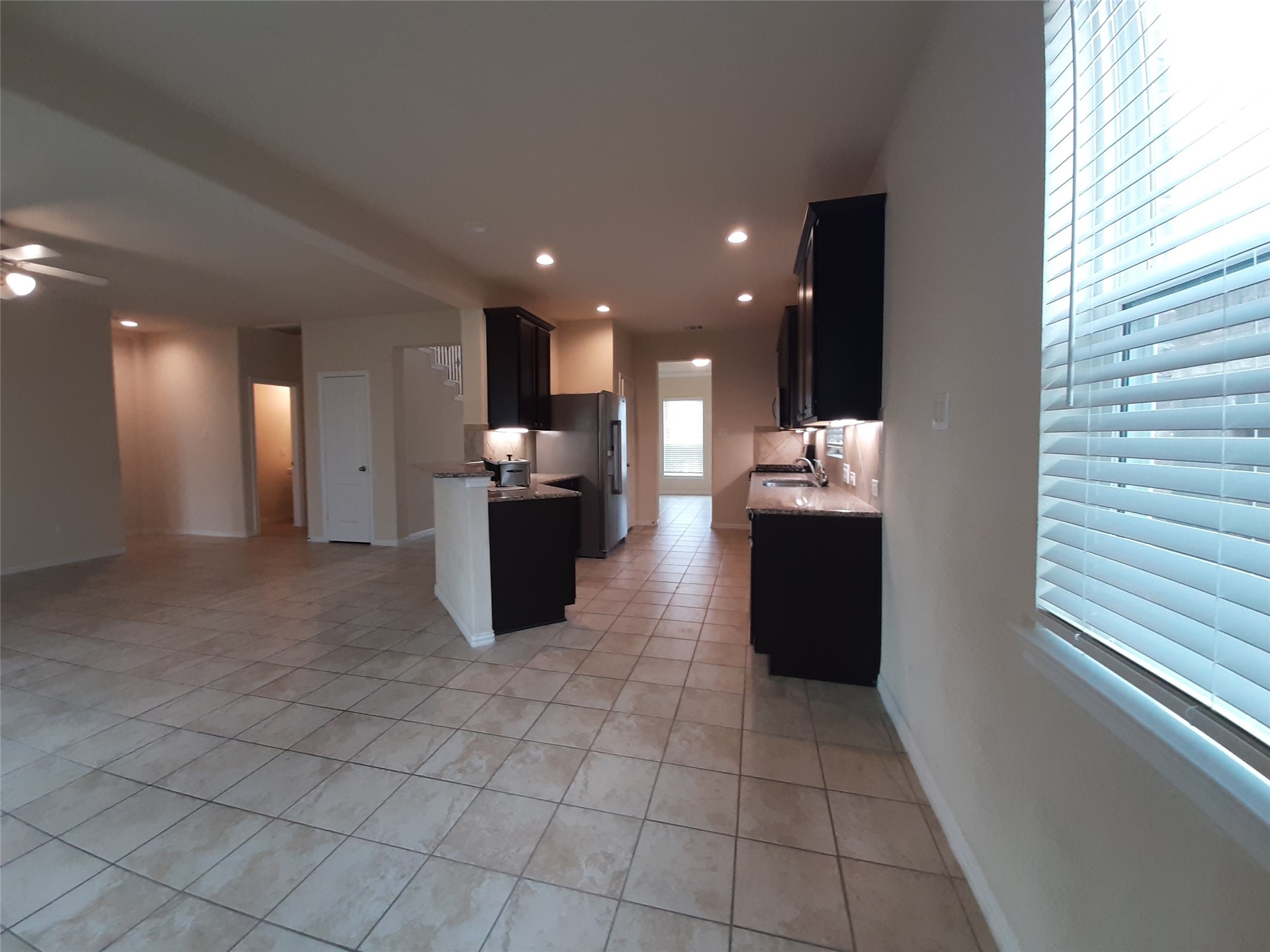 22830 Highland Bluff Lane Spring, TX 77373 - Photo 12 of 39 a kitchen with stainless steel appliances kitchen island granite countertop a refrigerator and a stove