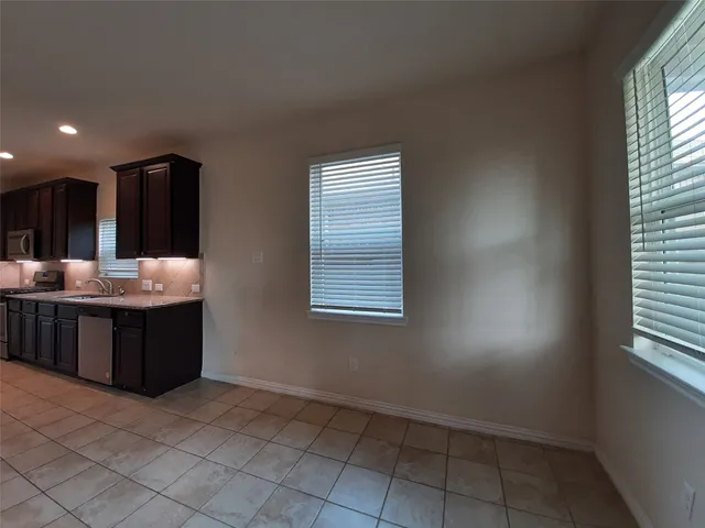 a bathroom with a tub vanity and window
