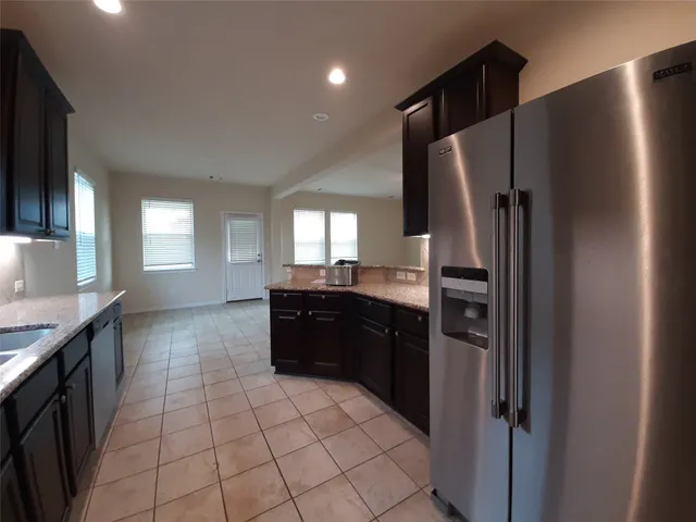 a kitchen with a refrigerator and a sink