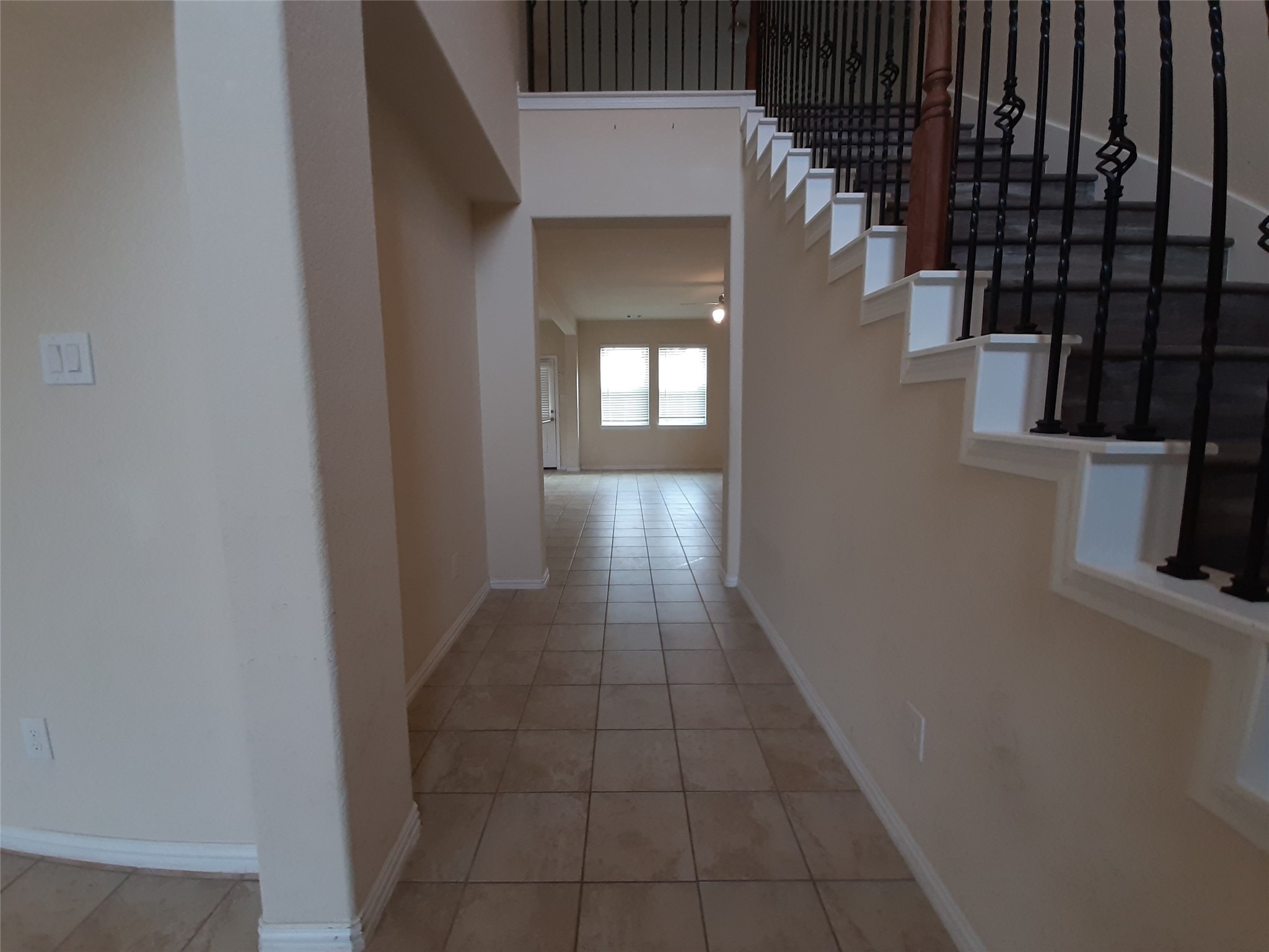 22830 Highland Bluff Lane Spring, TX 77373 - Photo 6 of 39 a hallway with wooden floor windows and a kitchen view