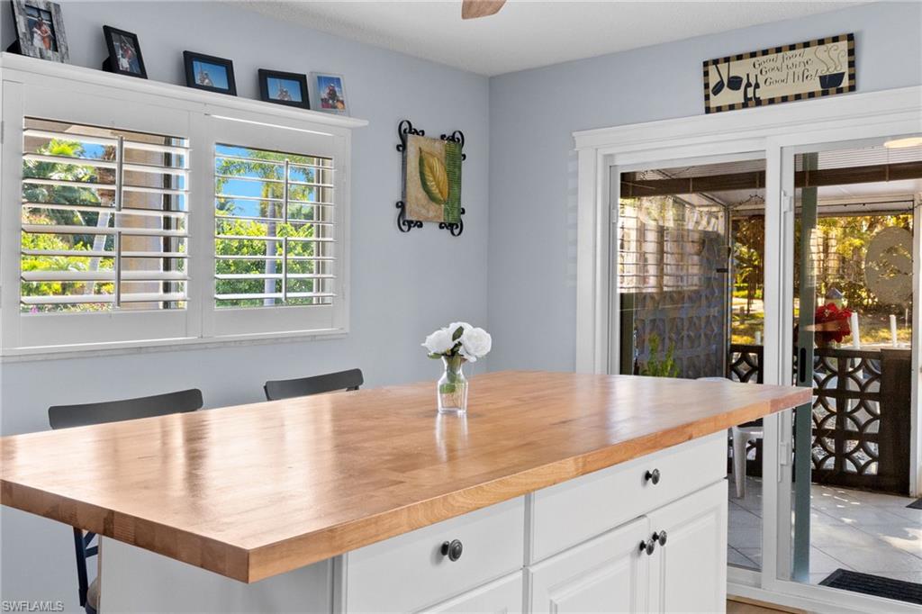 1686 Blue Point Avenue, Unit A1 Naples, FL 34102 - Photo 13 of 38 a kitchen with a sink and a large window