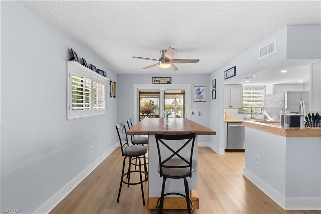 1686 Blue Point Avenue, Unit A1 Naples, FL 34102 - Photo 16 of 38 a dining room with furniture and window