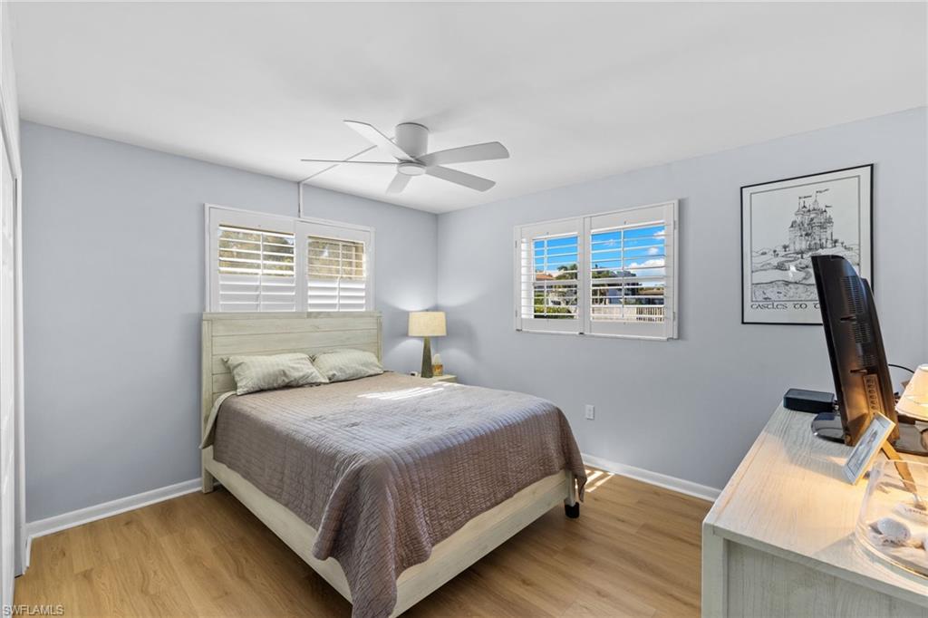 1686 Blue Point Avenue, Unit A1 Naples, FL 34102 - Photo 19 of 38 a bedroom with a bed and a window