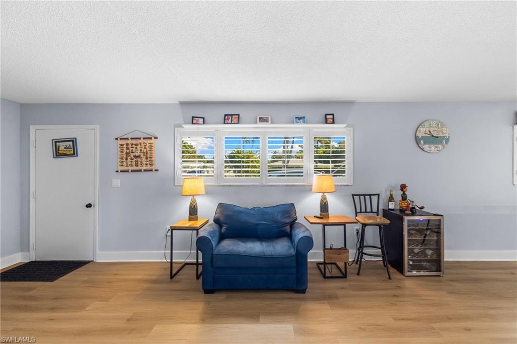 1686 Blue Point Avenue, Unit A1 Naples, FL 34102 - Photo 2 of 38 a living room with furniture and a window
